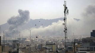 Smoke from airstrikes is seen rising over the city skyline of tehran in Iran