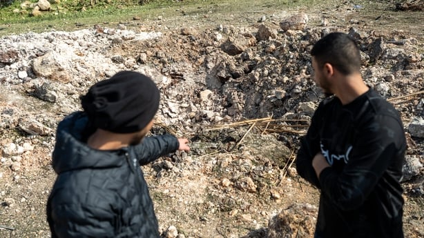 ZARZIR, ISRAEL - MARCH 13: Men look at a crater outside a home destroyed by an Iranian missile strike on March 13, 2026 in Zarzir, Israel. Israel's ambulance service said that more than 50 people were treated for injuries due to the strike. Iran has continued firing waves of drones and missiles at I