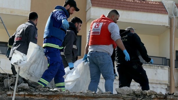 First aid responders evacuate a body from the site