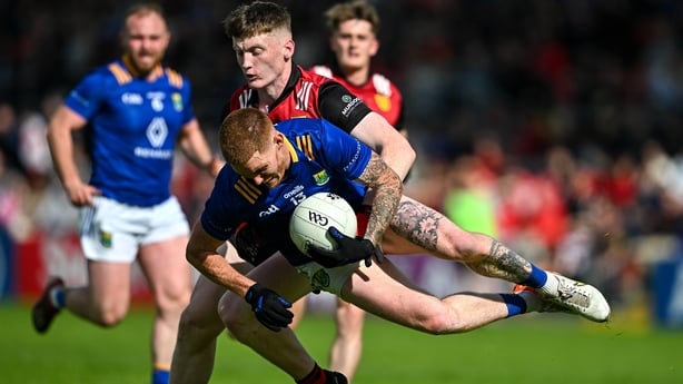 15 June 2024; Jonathan Carlin of Wicklow is fouled by Odhran Murdock of Down during the Tailteann Cup quarter-final match between Down and Wicklow at Páirc Esler in Newry, Down. Photo by Sam Barnes/Sportsfile
