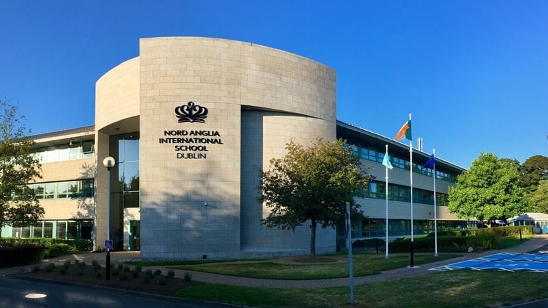 An image of a new school building with a blue sky background
