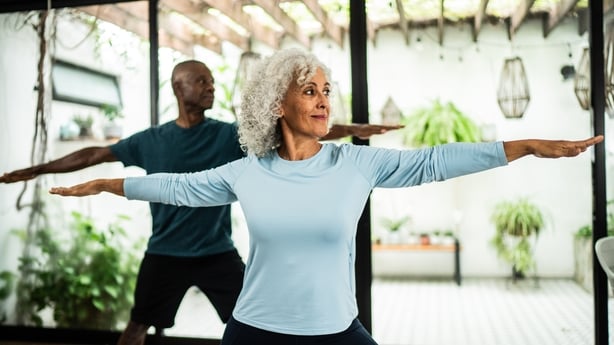 senior couple doing yoga at home