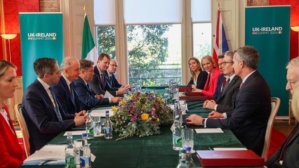 UK Prime Minister Keir Starmer, Taoiseach Michael Martin and senior ministers from both governments sit at a table.