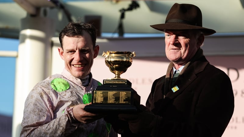 Jockey Paul Townend celebrates with the trophy alongside winning trainer Willie Mullins after victory in the Boodles Cheltenham Gold Cup Chase with Gaelic Warrior on day four of the 2026 Cheltenham Racing Festival at Prestbury Park in Cheltenham, England.