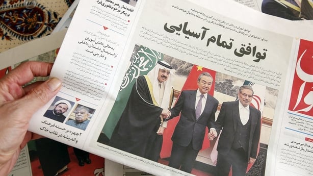 A man in Tehran holds a local newspaper reporting on its front page the China-brokered deal between Iran and Saudi Arabia to restore ties, signed in Beijing the previous day, on March, 11 2023. - Riyadh and Tehran announced on March 10 that after seven years of severed ties they would reopen embassi
