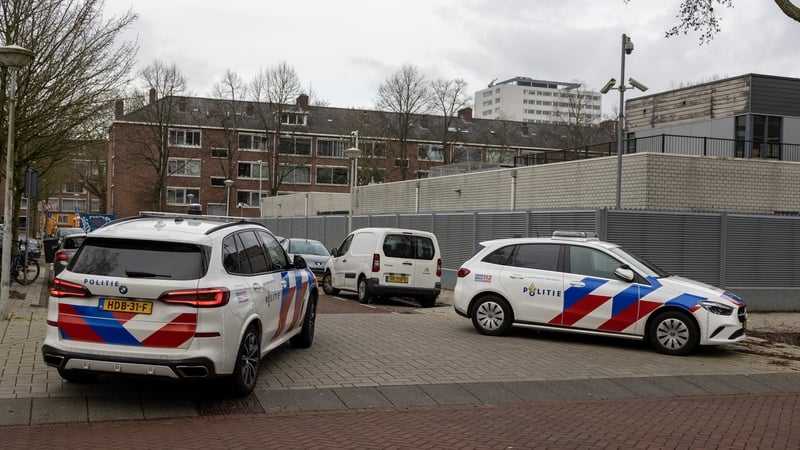 Police vehicles are parked outside a Jewish school where an explosion was reported overnight in Amsterdam
