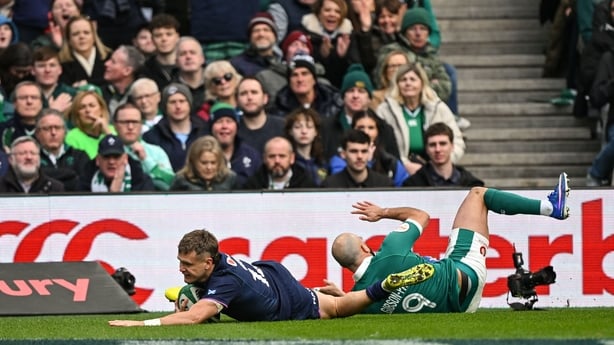 14 March 2026; Darcy Graham of Scotland dives over to score his side's first try despite the tackle of Jamison Gibson-Park of Ireland during the Guinness 6 Nations Rugby Championship match between Ireland and Scotland at the Aviva Stadium in Dublin. Photo by Ramsey Cardy/Sportsfile