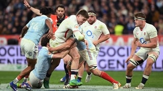 Tommy Freeman of England is challenged by fra13during the Guinness Six Nations 2026 match between France and England at Stade de France on March 14, 2026 in Paris, France.