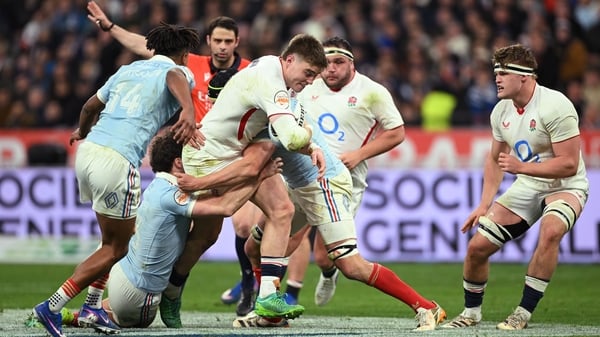 Tommy Freeman of England is challenged by fra13during the Guinness Six Nations 2026 match between France and England at Stade de France on March 14, 2026 in Paris, France.