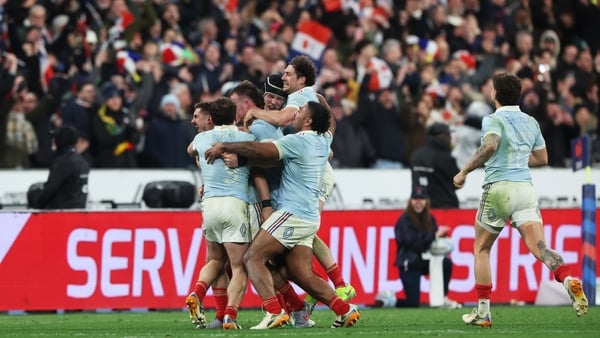 Players of France celebrate with Thomas Ramos of France (obscured) after he kicked the match winning points from a penalty kick to secure the Six Nations title during the Guinness Six Nations 2026 match between France and England at Stade de France on Mar