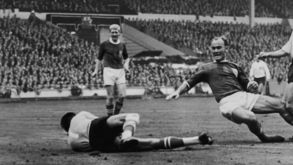 Yugoslavian goalkeeper Milutin Soskic (centre) and Czech centre-half Jan Popluhar of the Rest of the World squad fail to stop a shot by England outside-right Terry Paine (right), resulting in a 1-0 lead to England in the Football Association Centenary mat