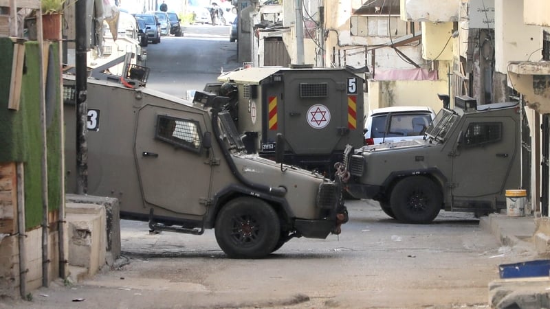 Israeli military vehicles seen blocking the street during a raid in Balata refugee camp.