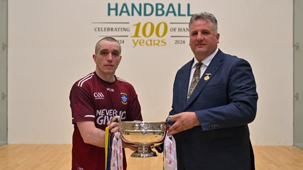 14 March 2026; Robbie McCarthy of Westmeath is presented with the Gael Linn cup by Kevin Cooke, Presidnet of GAA Handball after his victory in the oneills.com 4-Wall All Ireland Championships Men's final match between Robbie McCarthy of Westmeath and Diarmaid Nash of Clare at The National Handball C