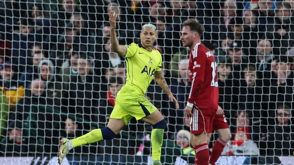 Tottenham Hotspur's Brazilian striker #09 Richarlison (L) celebrates after scoring his team's first goal to equalise, during the English Premier League football match between Liverpool and Tottenham Hotspur at Anfield in Liverpool, north west England on M