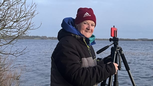 Woman with her phone on a tripod