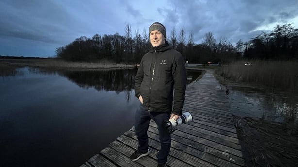 Man standing on a pier over Lough Ennell