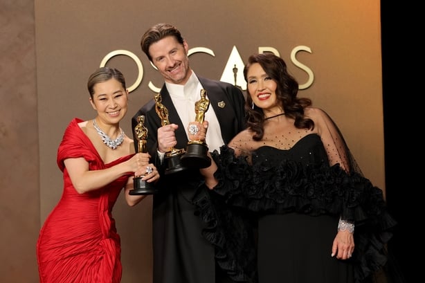Maggie Kang, Chris Appelhans, and Michelle L.M. Wong, winners of the Best Animated Feature Film Award for KPop Demon Hunters, pose in the press room during the 98th Oscars at Dolby Theatre on 15 March, 2026 in Hollywood, California. (Photo by Brianna Bryson/Getty Images)