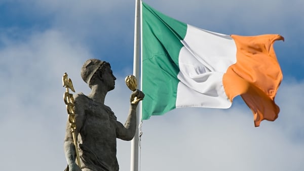 The Irish flag flying over the GPO with a statue in foreground