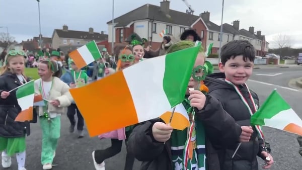 Children wave Irish flags at mini St Patrick's Day parade