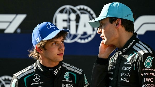 Mercedes' Italian driver Kimi Antonelli (L) celebrates winning the pole position with second-placed Mercedes' British driver George Russell after the qualifying session ahead of the Formula One Chinese Grand Prix at the Shanghai International Circuit in S