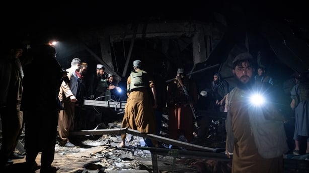 Afghan rescue teams and Taliban security personnel search for bodies under the rubble 