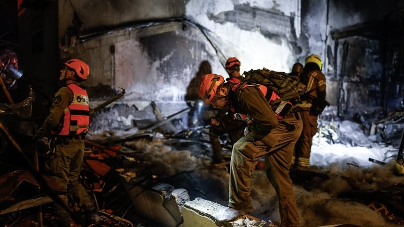 Firefighters and rescuers work at the site of a strike in the northern Israeli city of Nahariya on March 16, 2026. Lebanon's Hezbollah said it launched an attack on March 16 targeting Nahariya, where first responders reported a man was wounded