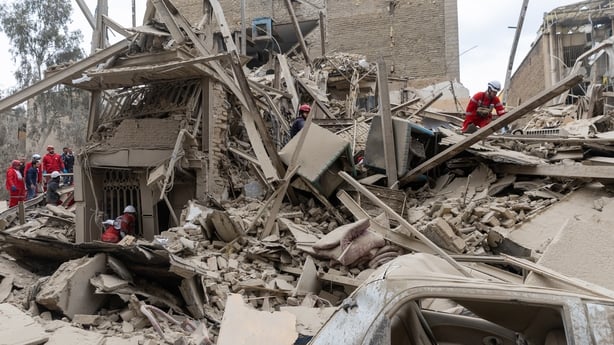 TEHRAN, IRAN - MARCH 16: Emergency crews search the rubble following a strike on a residential building on March 16, 2026 in central Tehran, Iran. The United States and Israel continued their joint attack on Iran that began on February 28. Iran retaliated by firing waves of missiles and drones at Is