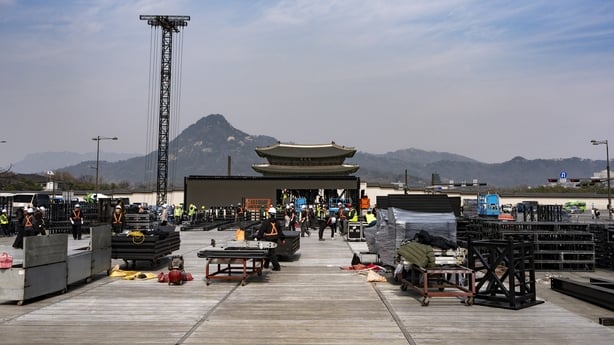 Workers assemble stage structures at Gwanghwamun Square in Seoul, South Korea, on March 16, 2026, ahead of a comeback performance by BTS