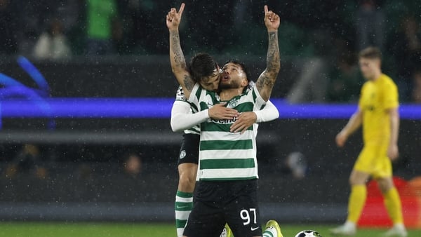 Sporting Lisbon's Colombian forward #97 Luis Suarez celebrates scoring his team's third goal with Sporting Lisbon's Portuguese midfielder #23 Daniel Braganca during the UEFA Champions League last 16 second leg football match between Sporting CP and Bodoe/