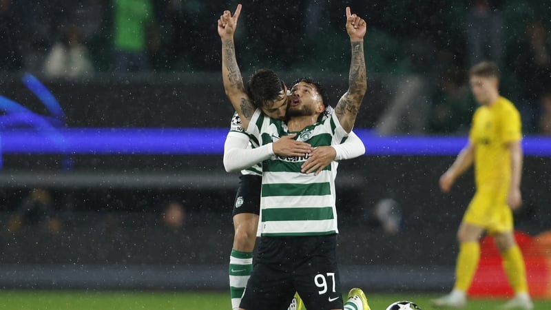 Sporting Lisbon's Colombian forward #97 Luis Suarez celebrates scoring his team's third goal with Sporting Lisbon's Portuguese midfielder #23 Daniel Braganca during the UEFA Champions League last 16 second leg football match between Sporting CP and Bodoe/