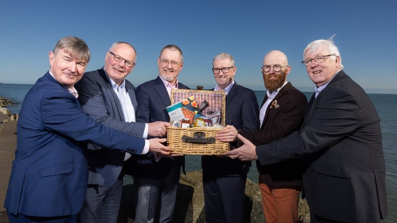 Image of a group of business men holding a basket of Irish food products