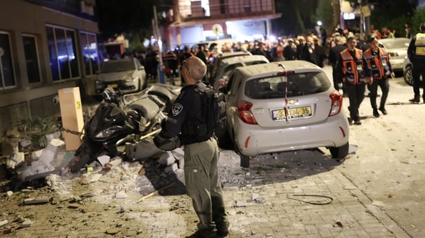 Police and first responders work at a scene where an apartment was damaged 