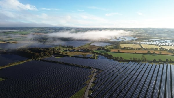 Aerial image of a solar farm spread across fields in the countryside