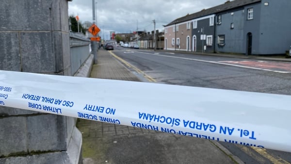a garda crime scene tape across a street