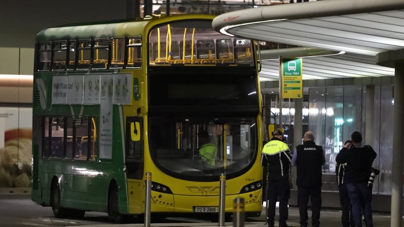 Gardaí stand around a Dublin Bus