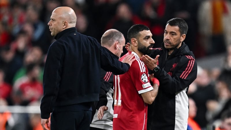 Liverpool's Mo Salah is greeted after being substituted against Galatasaray by manager Arne Slot, left, and assistant coach Giovanni van Bronckhorst