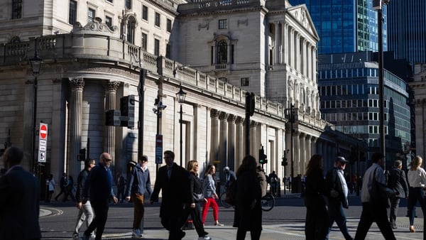 Commuters pass the Bank of England in London