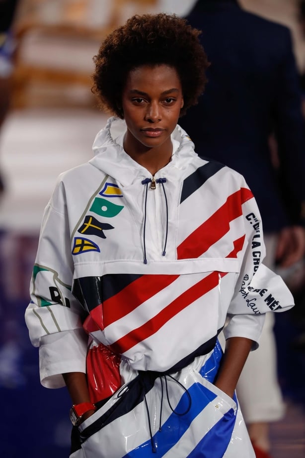 a model on a runway wearing a tech jacket
