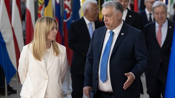 Hungary's Prime Minister Viktor Orban (R) speaks with Italy's Prime Minister Giorgia Meloni 