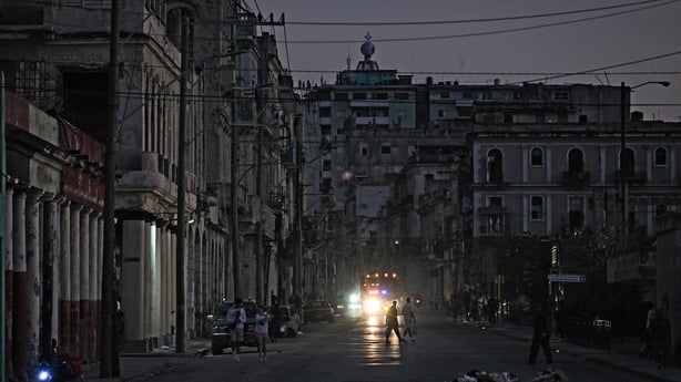 People walk down a street during a blackout in Havana