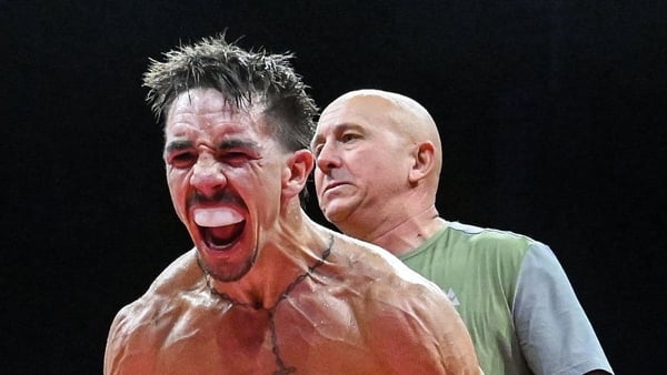 Michael Conlan, left, is held by his coach Grant Smith after winning his vacant WBC International Featherweight title bout against Jack Bateson at the 3 Arena in Dublin.