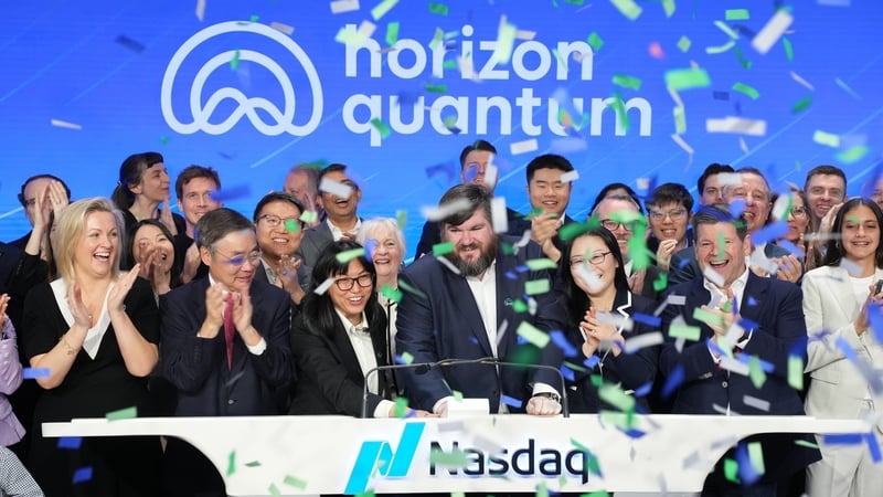 Image of a group cheering and clapping with the Horizon Quantum signage in the background on a stage with Nasdaq sigage