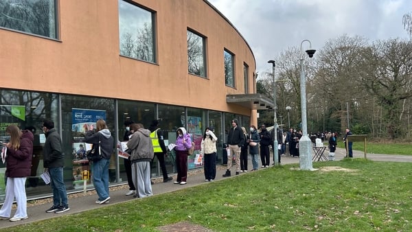 Students queuing to receive vaccines and antibiotics at the University of Kent campus in Canterbury