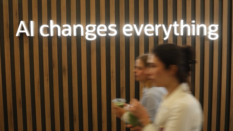 BERLIN, GERMANY - MARCH 04: Women walk past an illuminated sign that reads: "AI changes everything", in reference to artificial intelligence, at the Oracle stand at the 2026 ITB tourism trade fair on March 04, 2026 in Berlin, Germany. The ongoing U.S.-Isr