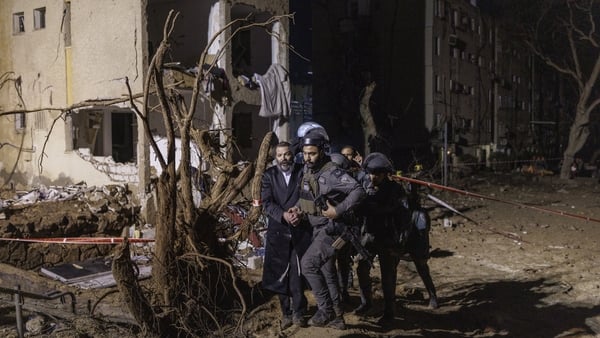 Israeli rescue forces work on a site where a missile from Iran hit in the city of Arad