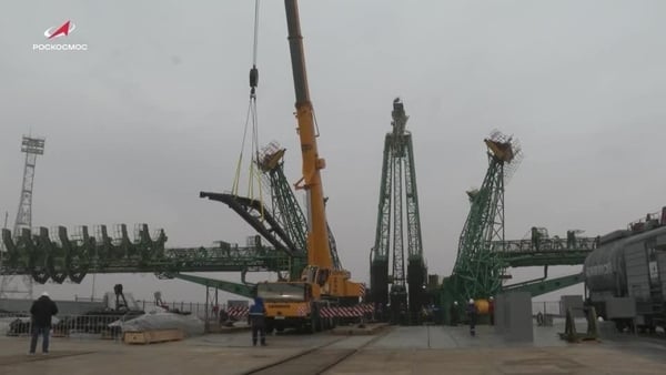 a yellow crane is seen at the sight of a launch pad for space rockets