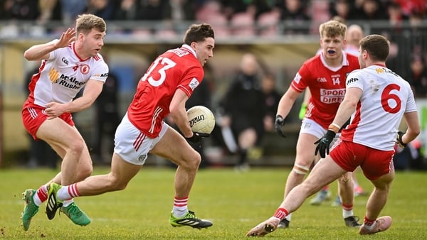 22 March 2026; Chris Og Jones of Cork in action against Cormac Quinn and Niall Devlin of Tyrone during the Allianz Football League Division 2 match between Tyrone and Cork at O'Neills Healy Park in Omagh, Tyrone. Photo by Oliver McVeigh/Sportsfile