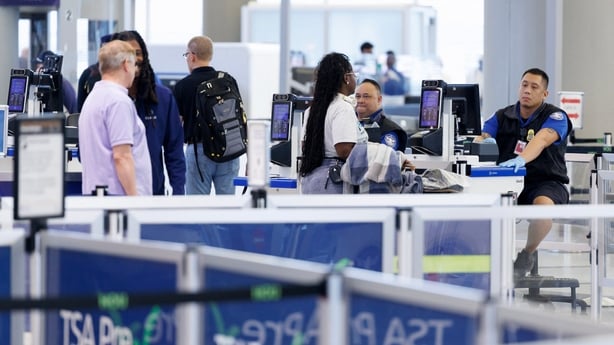 people queue at an airport security line