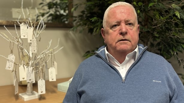 Gerry O'Reilly sits in front of a table.