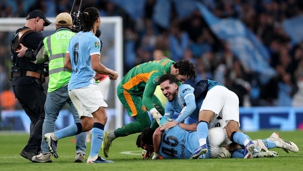 LONDON, ENGLAND - MARCH 22: James Trafford, Rayan Cherki and Abdukodir Khusanov of Manchester City celebrate after the team's victory in the Carabao Cup Final match Arsenal and between Manchester City at Wembley Stadium on March 22, 2026 in London, Englan